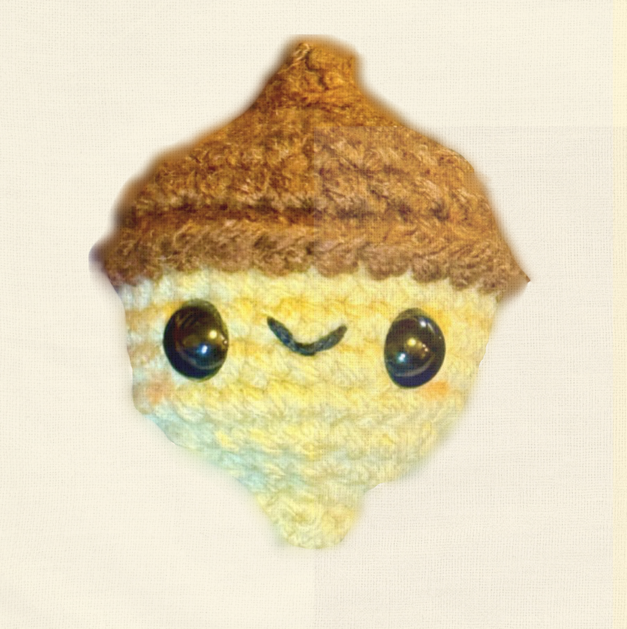 Augie the Acorn, a 2 inch handmade Chunkle Puff catnip toy by Feline Grove, shown alone on a neutral background. Rounded woven form with cap detail highlights artisan craftsmanship.