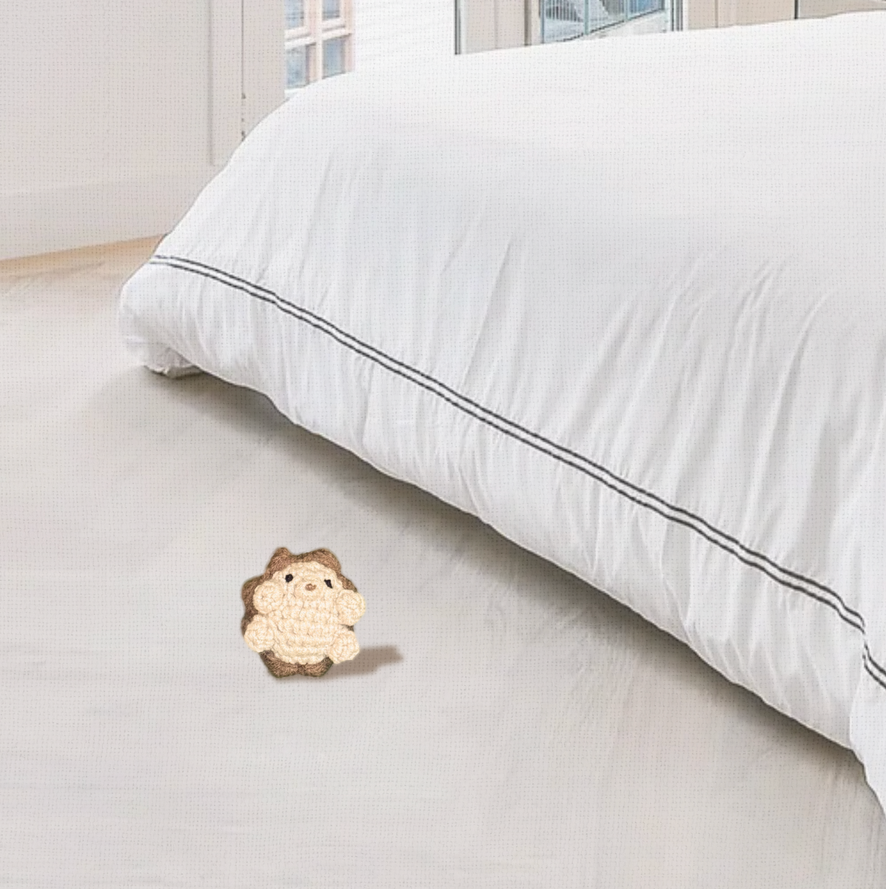 Lifestyle photo of Harold the Hedgehog, a handmade Chunkle Puff catnip toy by Feline Grove. Displayed in a refined interior with linen backdrop, styled for boutique elegance.