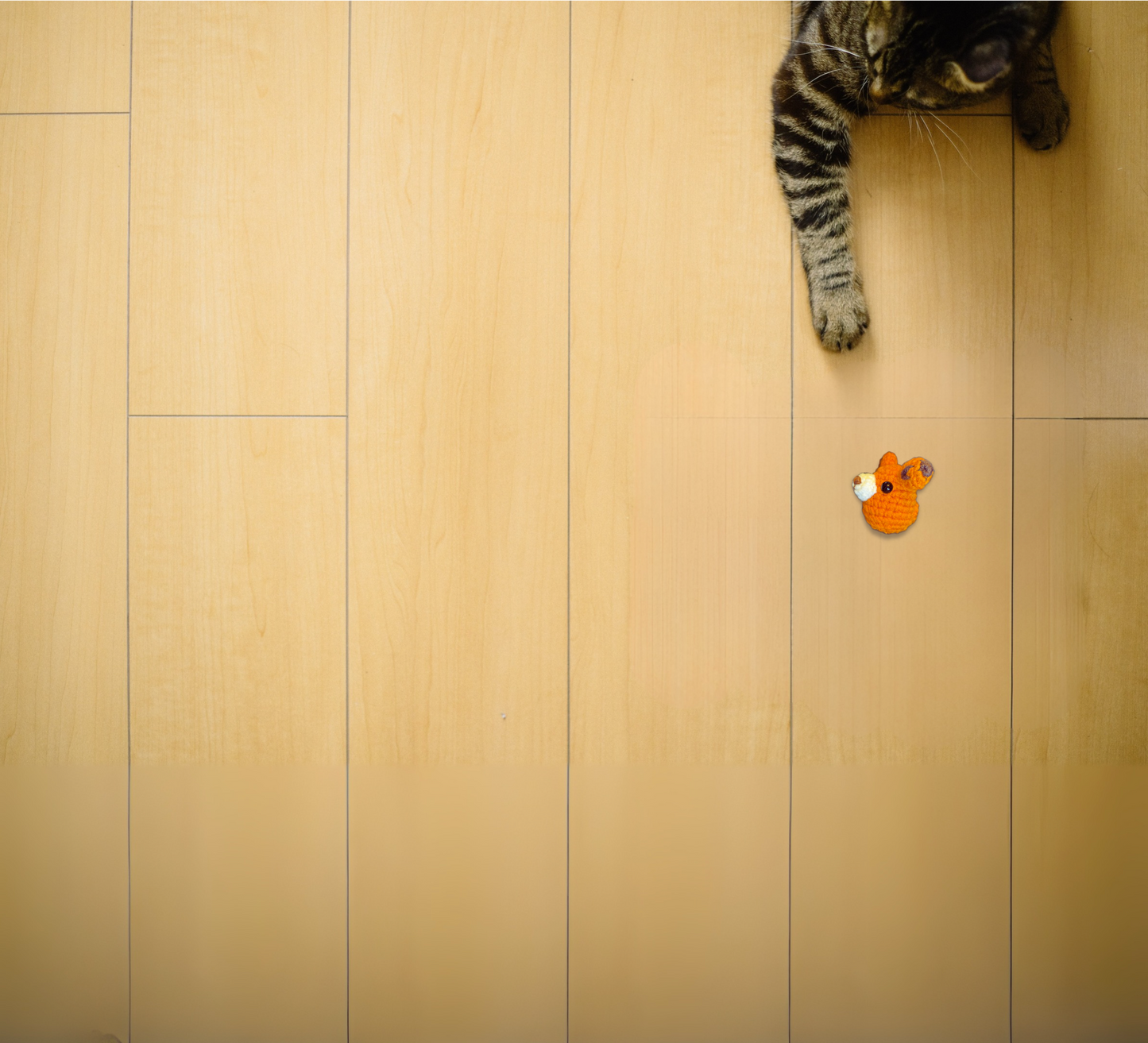 TJ the Fox, a handmade Chunkle Puff catnip toy measuring approx. 3.5 inches, shown beside a familiar object for scale. The woven fox form highlights playful small size and luxury detail for refined homes.