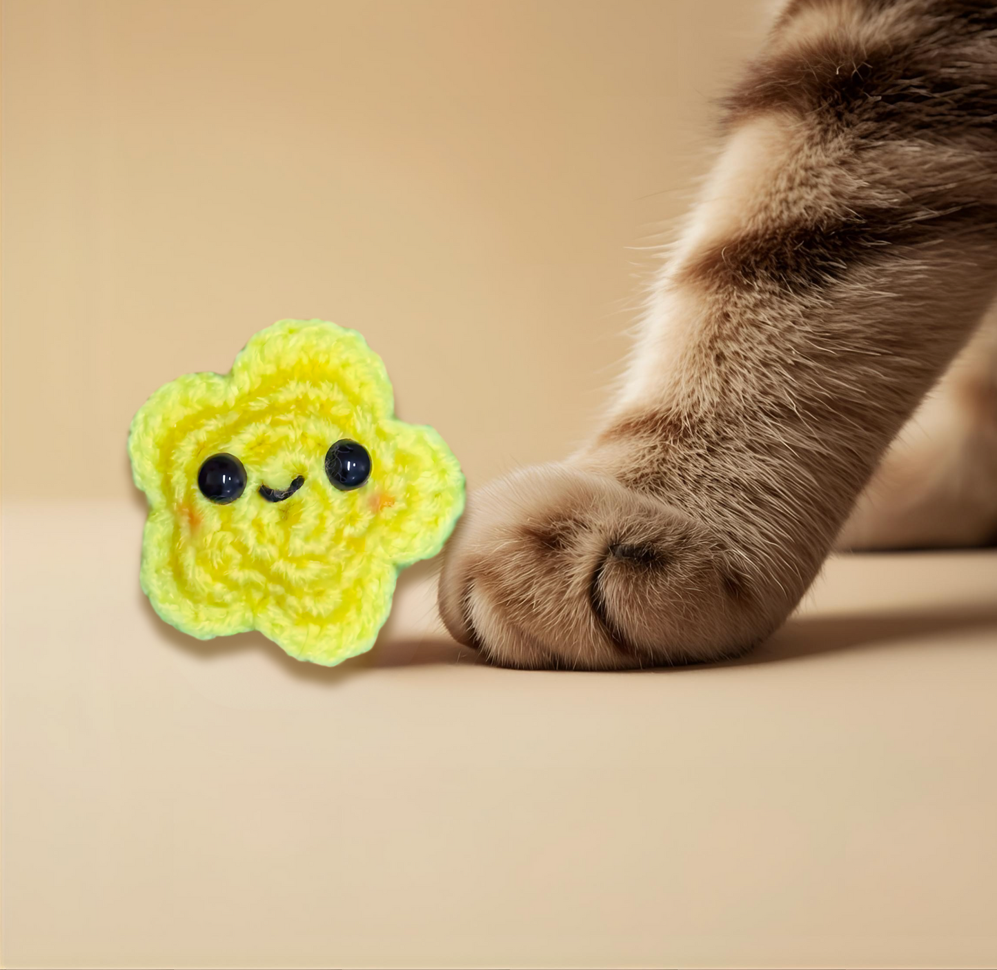 Twila L’Étoile, a handmade Chunkle Puff catnip toy measuring approx. 2 inches flat, shown beside a familiar object for scale. Star-shaped woven form highlights petite size and refined design.