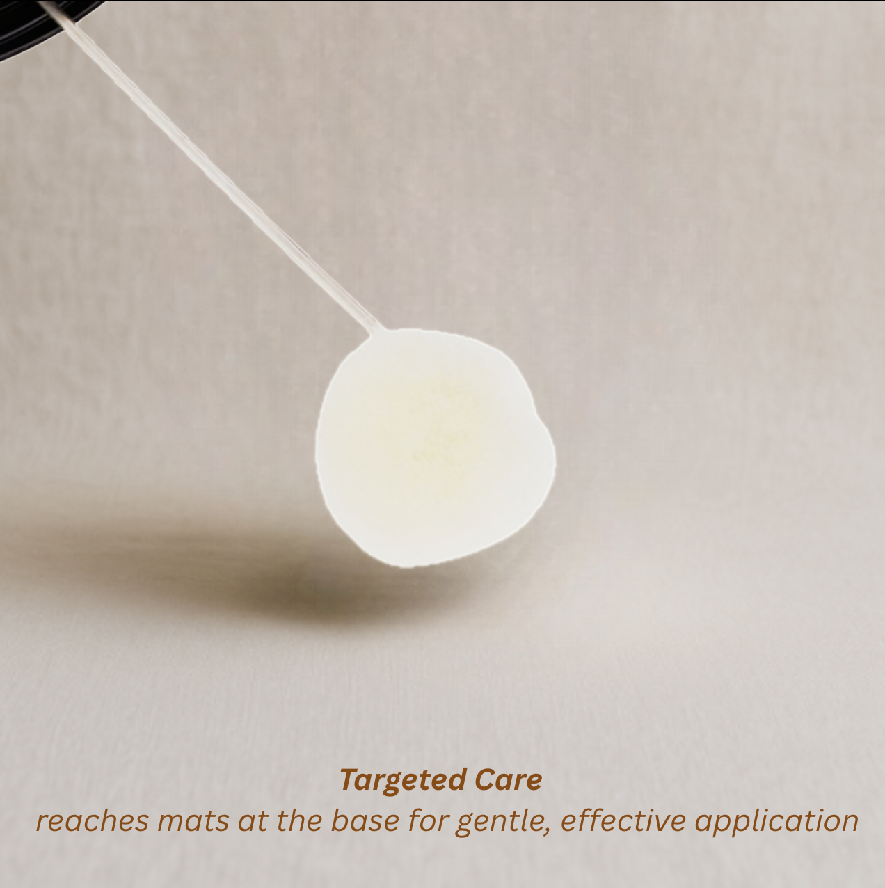 Close-up of Fluff Potion Number 9’s precision applicator cap with metal stem and fluffy tip, designed for accurate, gentle application at the base of kitty's mats.