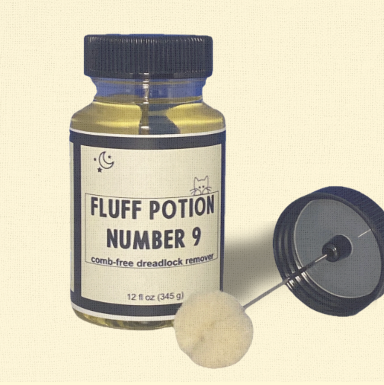 Fluff Potion Number 9, a 12 fl oz amber glass bottle with precision dauber cap by Minou Le-Mew, shown against a delicate cream colored backdrop. A luxury botanical no-comb mat remover for cats.