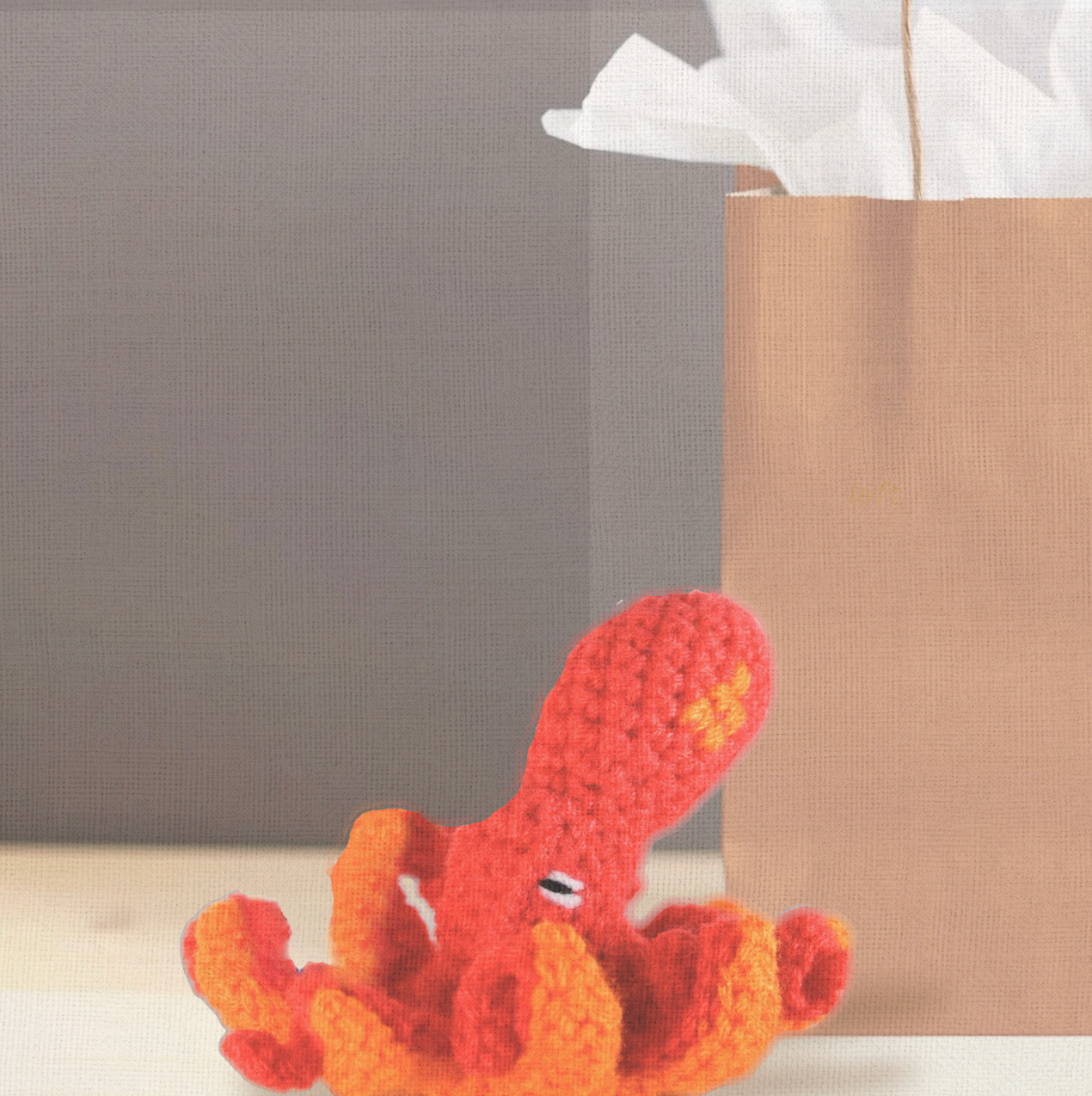 Julie the Kraken, a handmade Chunkle Puff catnip toy by Minou Le-Mew, presented with a boutique gift bag. The octopus-inspired design is styled as a luxury collectible piece.