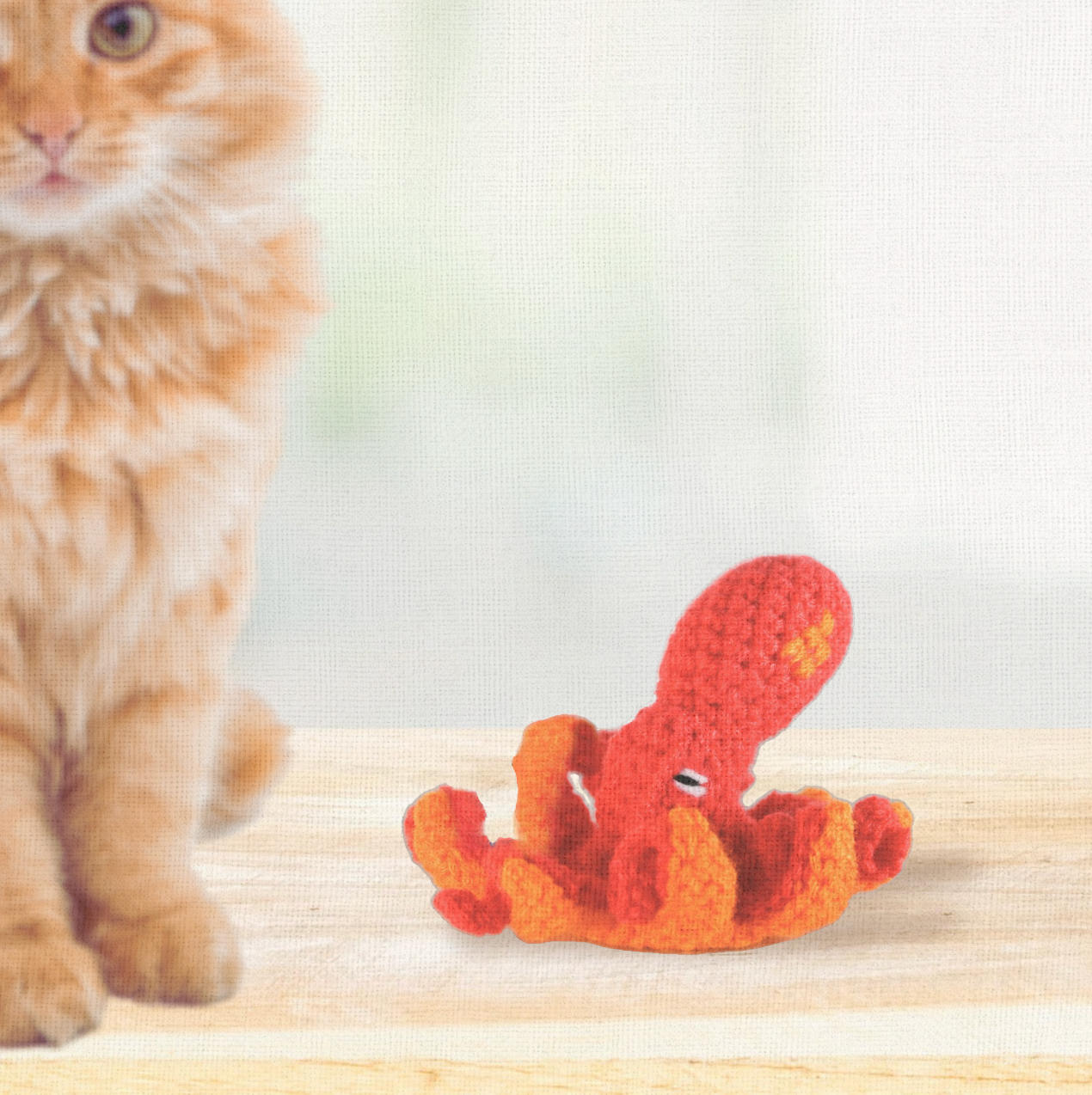Julie the Kraken, a 6 inch handmade catnip toy, shown beside a cat for scale. The octopus-inspired Chunkle Puff form combines flowing play with refined design.