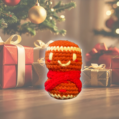 Knitted toy resembling a gingerbread girl front of Christmas presents and decorations to represent Catnip Chunkle toy for indoor cats infused with Miracle Nip botanicals from Minou Le-Mew