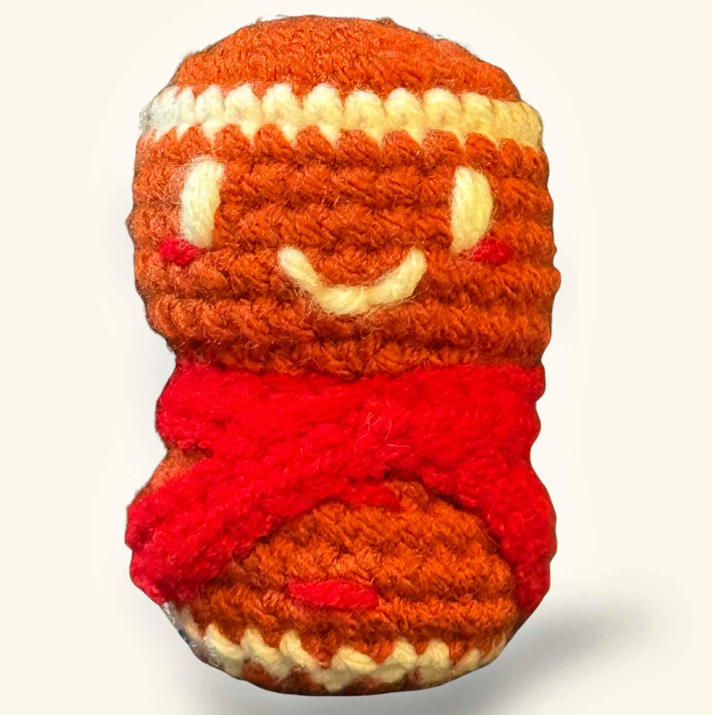 Knitted toy resembling a gingerbread man on a white background to represent a Christmas themed Chunkle catnip toy by Minou Le-Mew, infused with Miracle Nip botanicals for cats