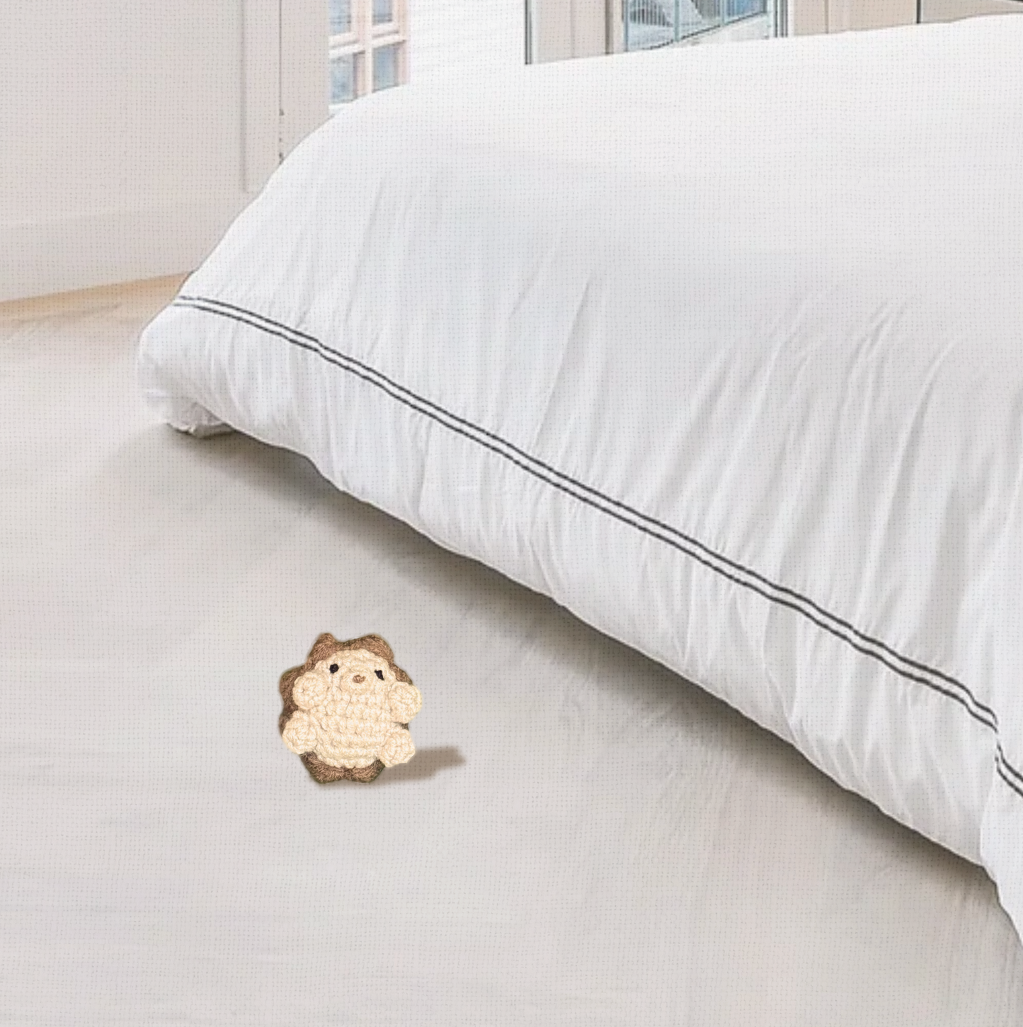 Hedgehog cat toy next to a bed in a bedroom setting