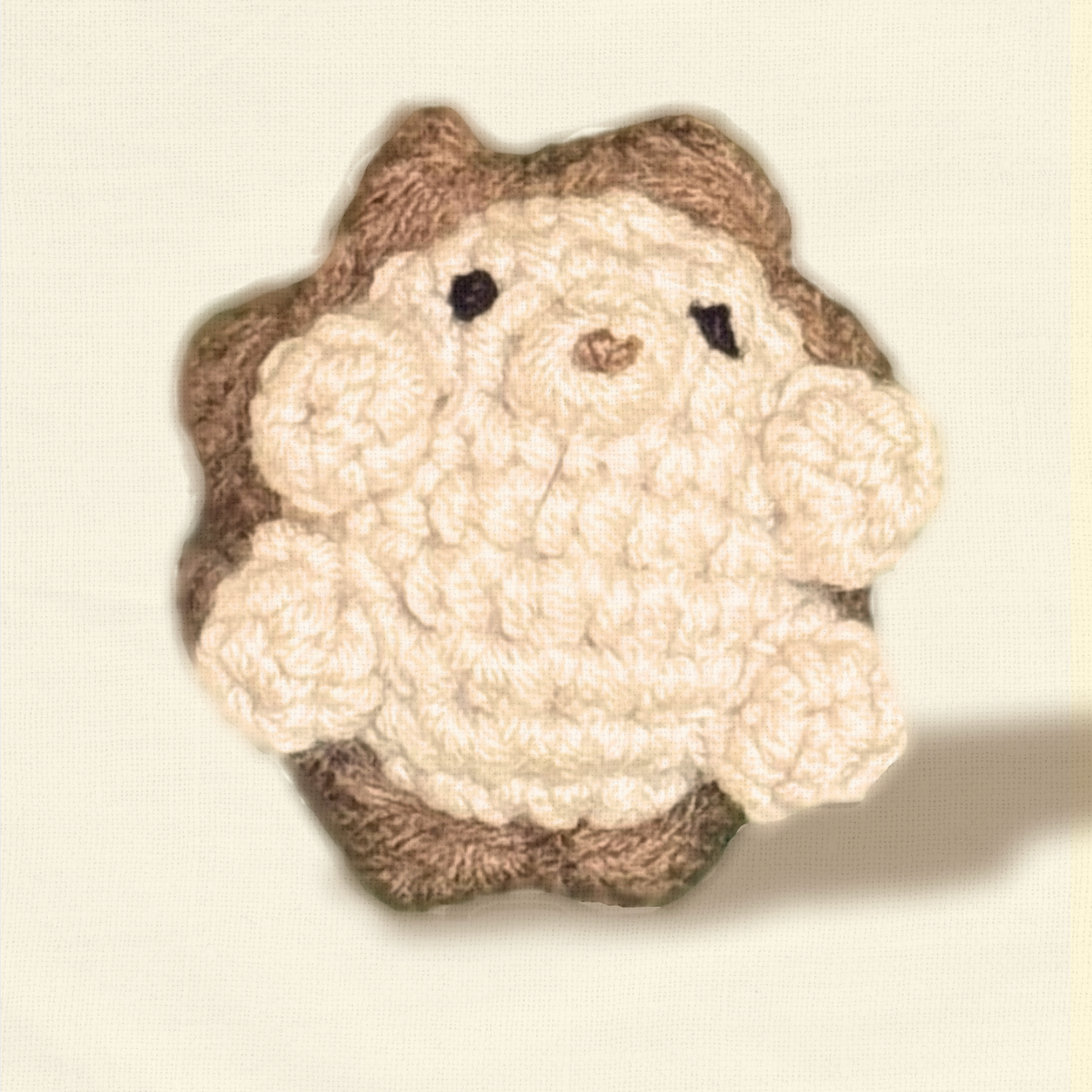Closeup of hedgehog cat toy on a cream colored background