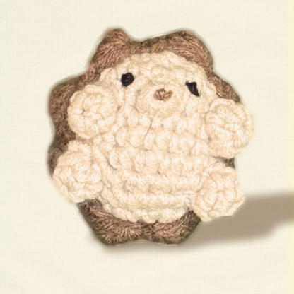 Closeup of hedgehog cat toy on a cream colored background