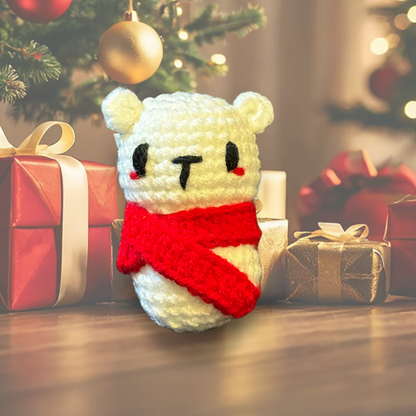 White plush cat toy with red scarf in front of Christmas decorations and presents to represent designer Chunkle catnip toy from Minou Le-Mew with Miracle Nip botanicals