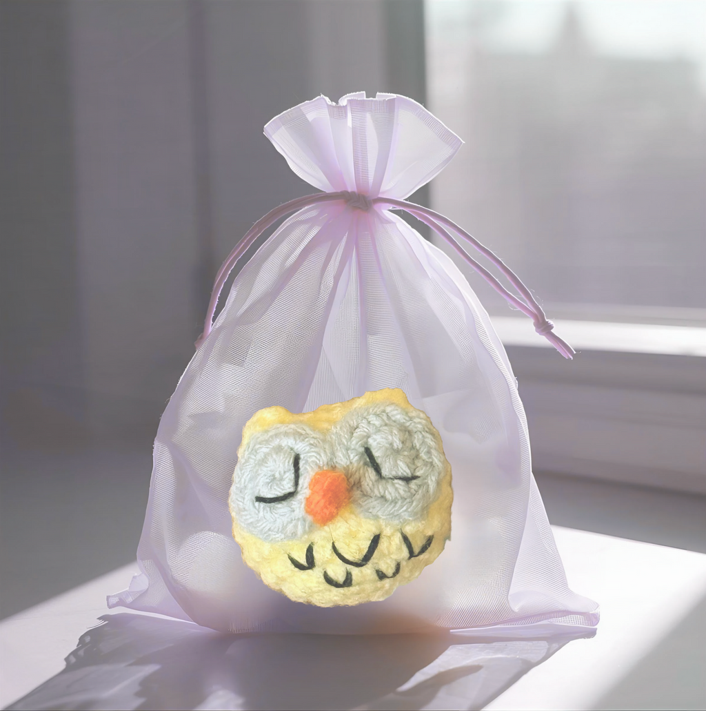 Yolk the Owl, a handmade Chunkle Puff catnip toy by Feline Grove, shown with a boutique gift box. The round owl toy is presented as a luxury collectible piece designed for refined gifting and feline play.