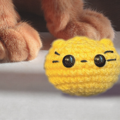 Pippa the Chonk, a 3.5 inch handmade weighted Chunkle Chunk catnip toy, shown next to a human hand for scale to demonstrate her round, substantial size