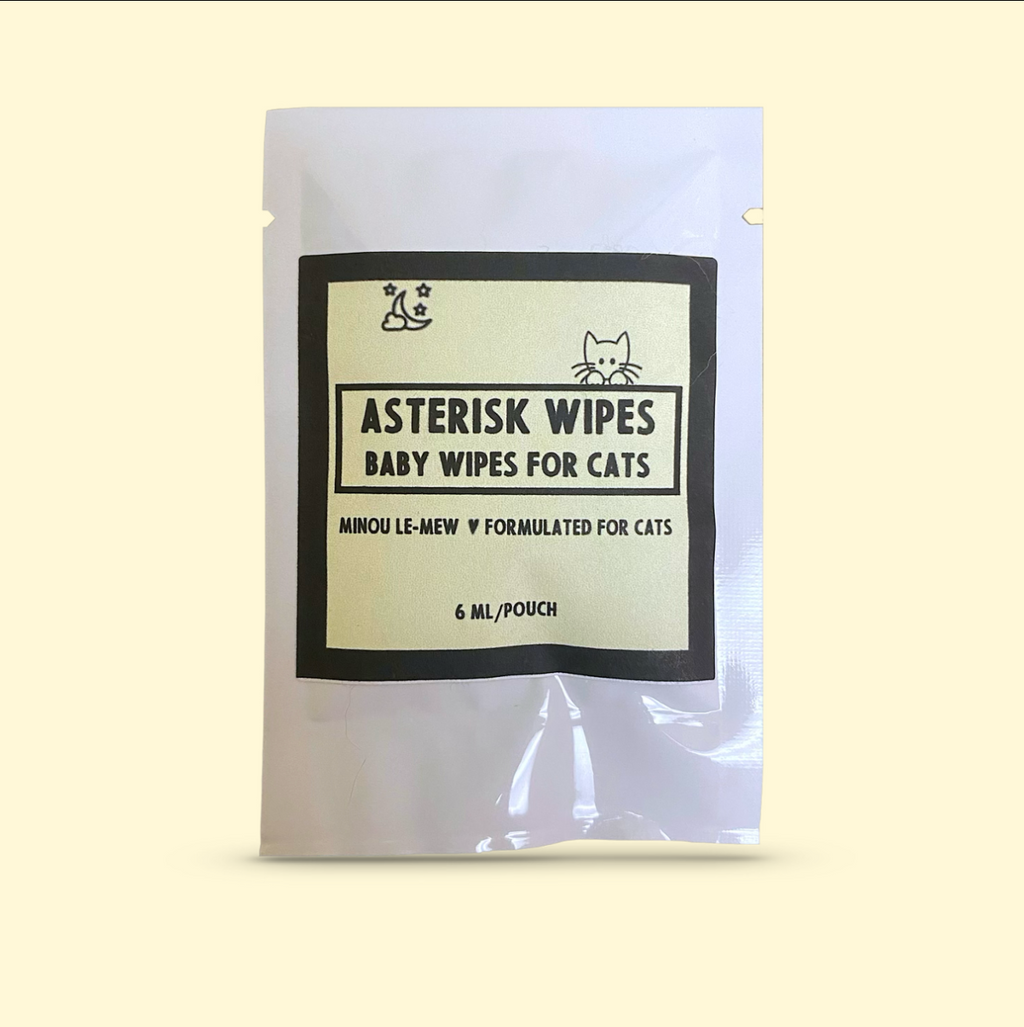 Asterisk Wipes, a 50-count pack of botanical cat hygiene wipes by Minou Le-Mew, displayed against a soft cream backdrop. Luxury wipes for refined feline care.