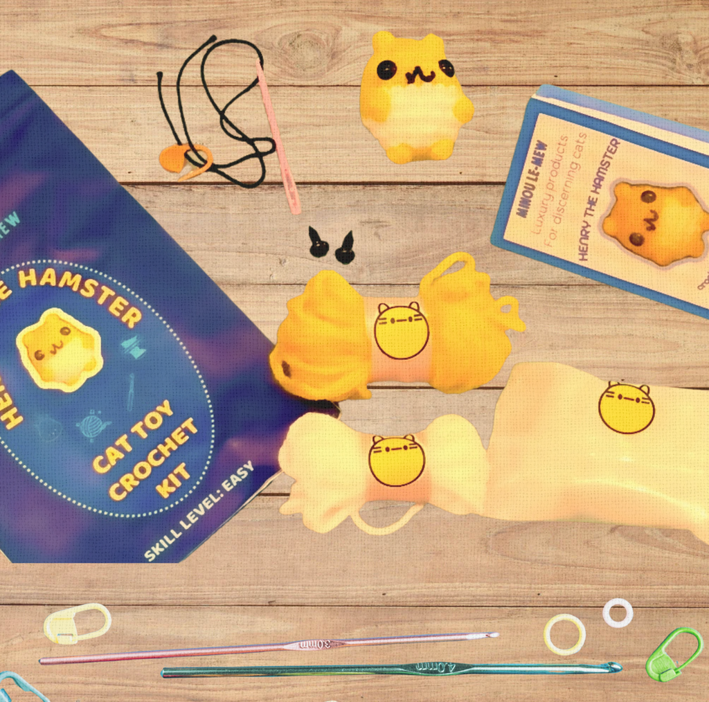 Cat Toy Crochet Kit components arranged on a blonde wooden plank, including yarn, hook, stuffing, instructions, and one finished handmade cat toy.