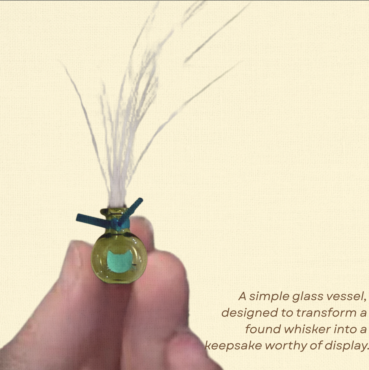 A hand holding a green glass Whisker Vase filled with whiskers, shown with overlay text describing its purpose as a keepsake display piece.