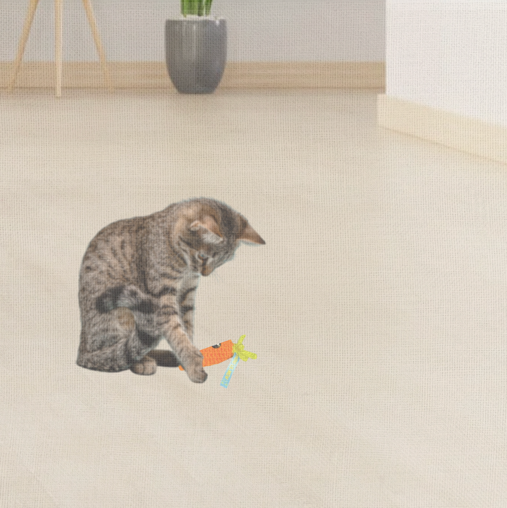 Cat playing with Lulu the Carrot, a handmade Chunkle Puff catnip toy. The bright woven carrot form is batted and carried, showing irresistible play appeal.