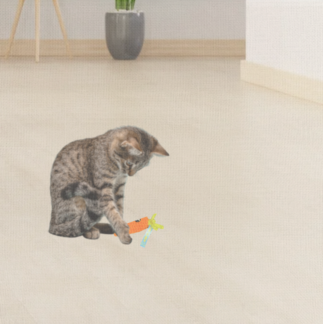 Cat playing with Lulu the Carrot, a handmade Chunkle Puff catnip toy. The bright woven carrot form is batted and carried, showing irresistible play appeal.