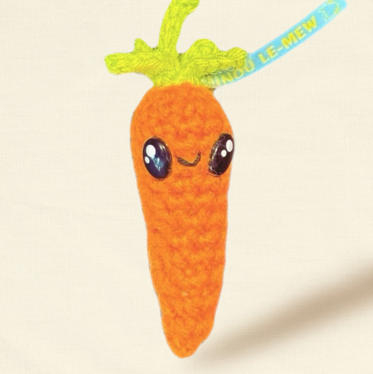 Lulu the Carrot, a 3.5 inch handmade Chunkle Puff catnip toy by Minou Le-Mew, shown alone on a neutral background. The woven carrot form highlights artisanal luxury design.
