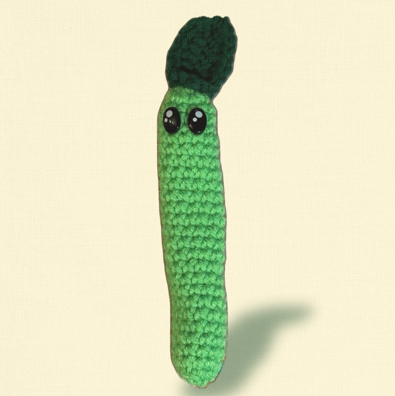 Noodle the Inchworm, a 3.5 inch handmade Chunkle Puff catnip toy by Minou Le-Mew, shown alone on a neutral background. Elongated woven form highlights artisanal craftsmanship.