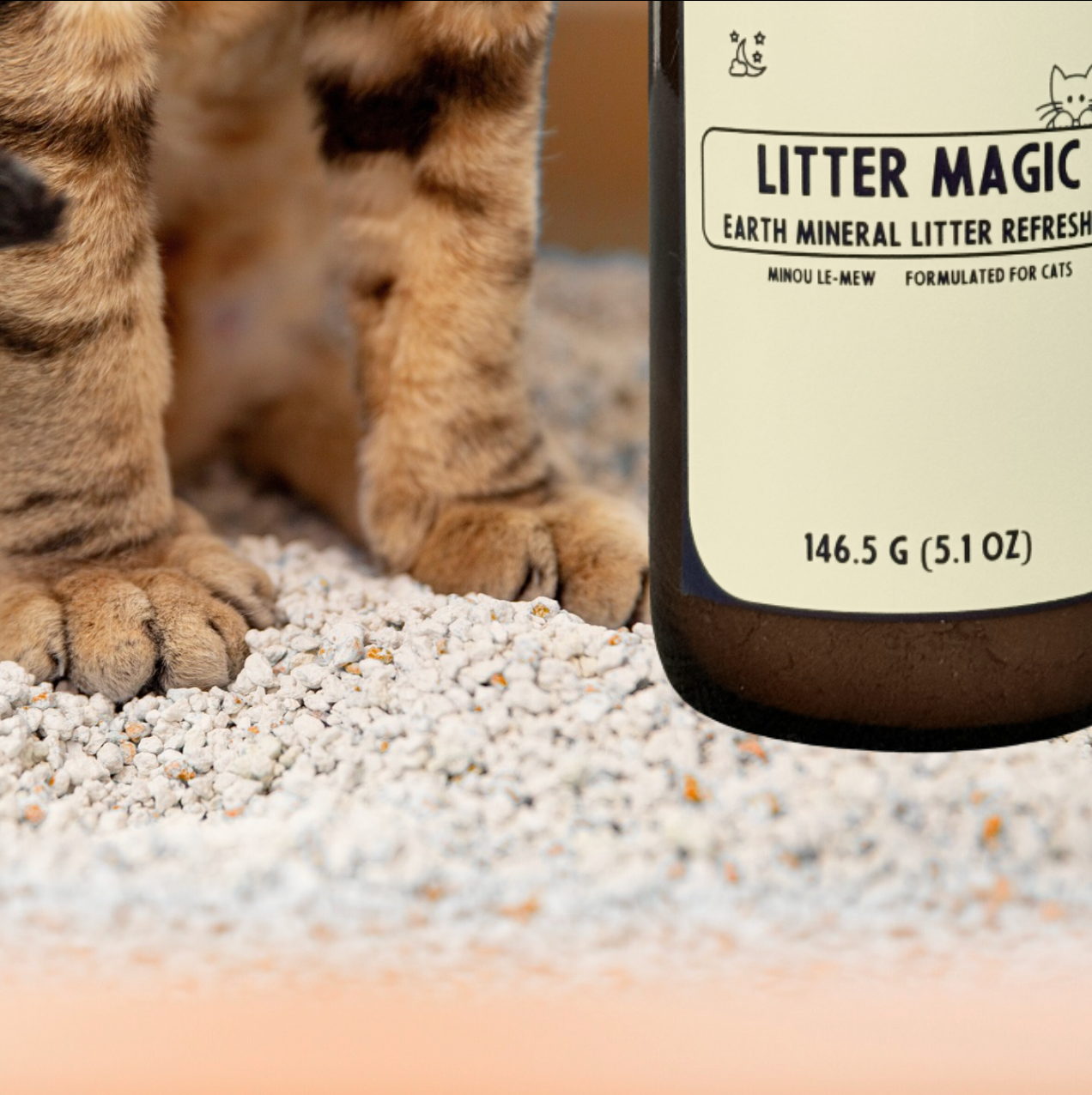 A cat in a litter box. Minou Le-Mew’s natural mineral refresher providing fragrance-free odor control for refined feline care is shown for scale.