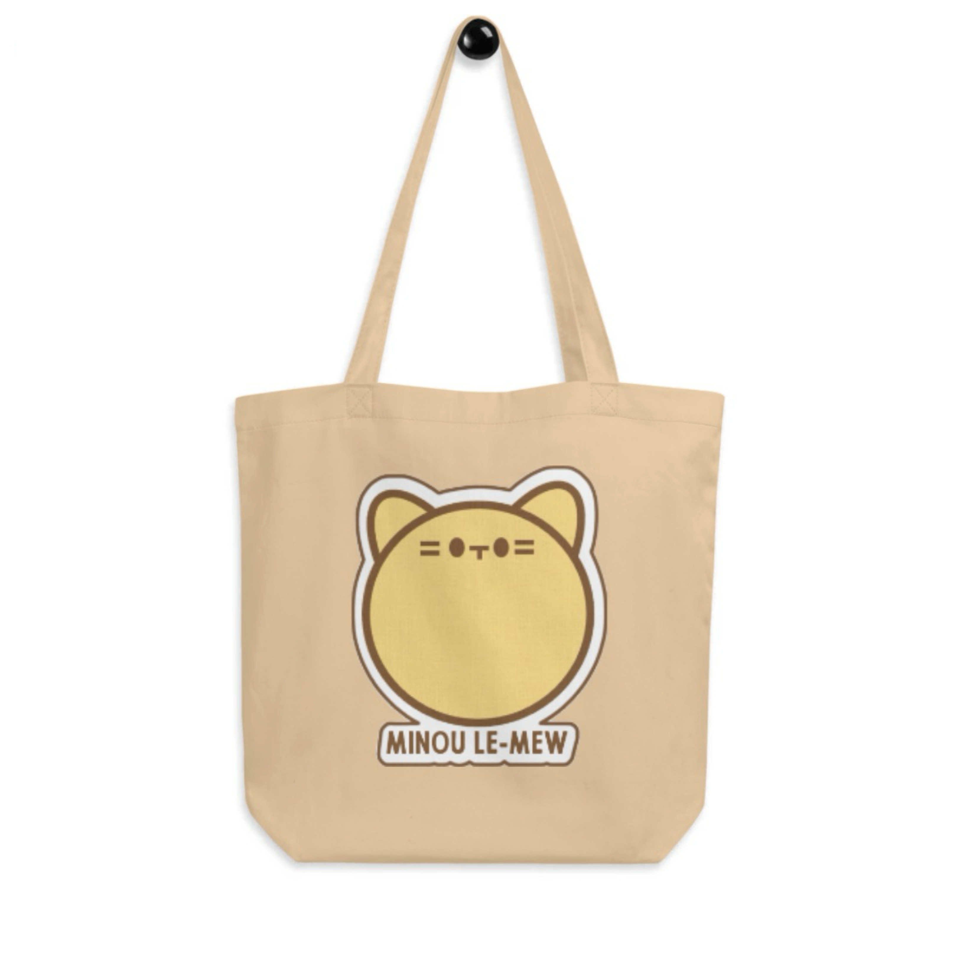 Beige tote bag with a cat illustration and 'MINOU LE-MEW' text on a white background